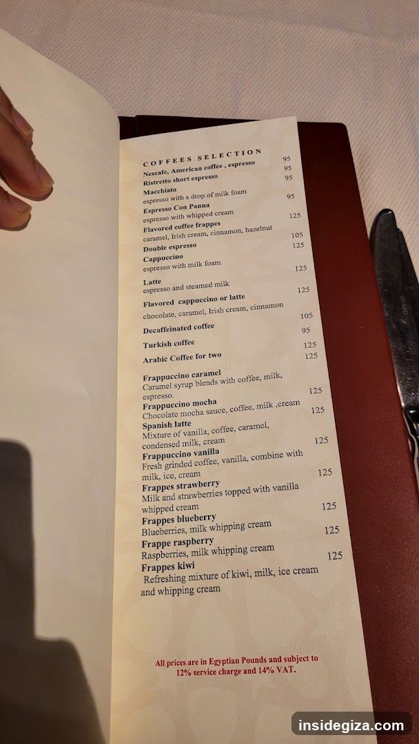 A printed coffee menu page showing various coffee drinks and frappes with prices in Egyptian Pounds.