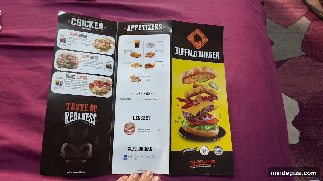 A printed menu from Buffalo Burger restaurant, featuring sections for Chicken Sandwiches, Appetizers, Extras, Dessert, and Soft Drinks. The menu includes images of food items like burgers and fries with prices listed in Thai Baht.