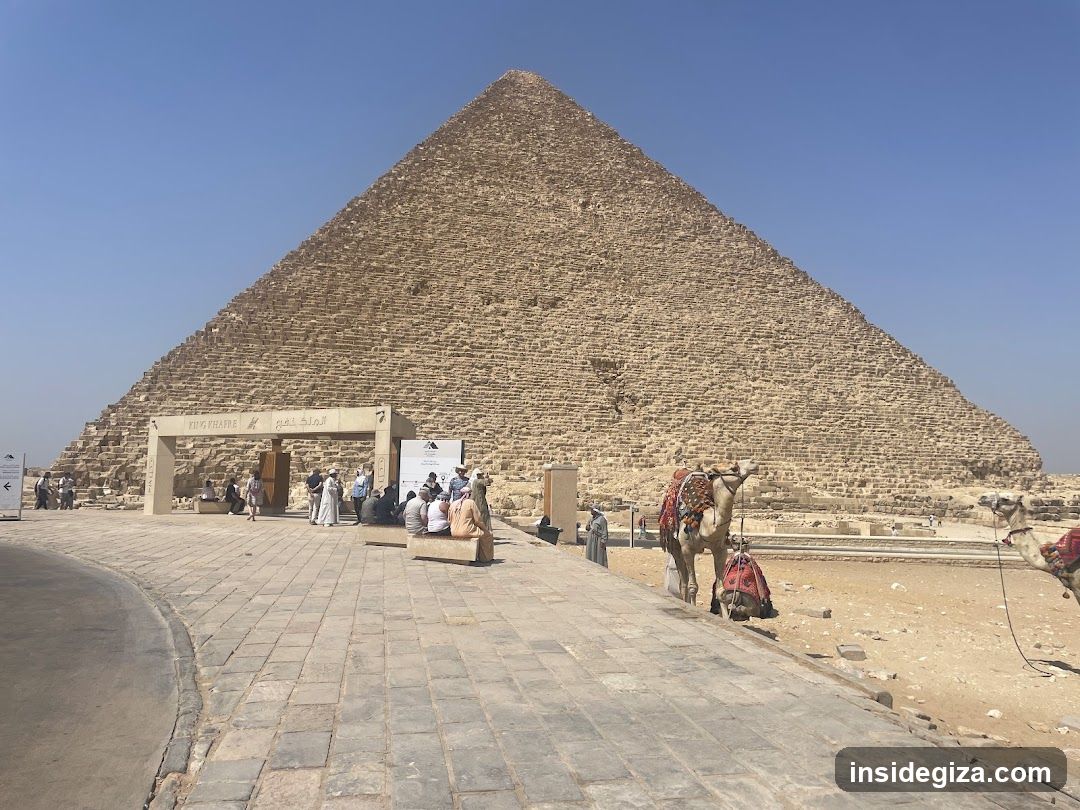 Pyramid of Giza with tourists and camels