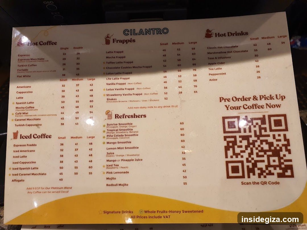 A close-up photo of a printed menu from a coffee shop called 'CILANTRO'. The menu is divided into sections for Hot Coffee, Frappés, Iced Coffee, and Hot Drinks.