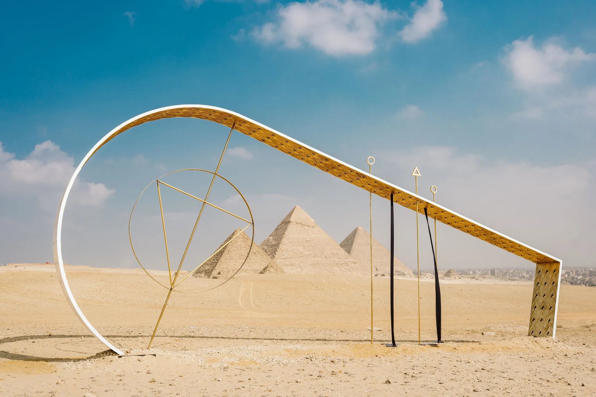Contemporary sculpture on the Giza Plateau from a previous Forever Is Now edition, with the pyramids behind the work