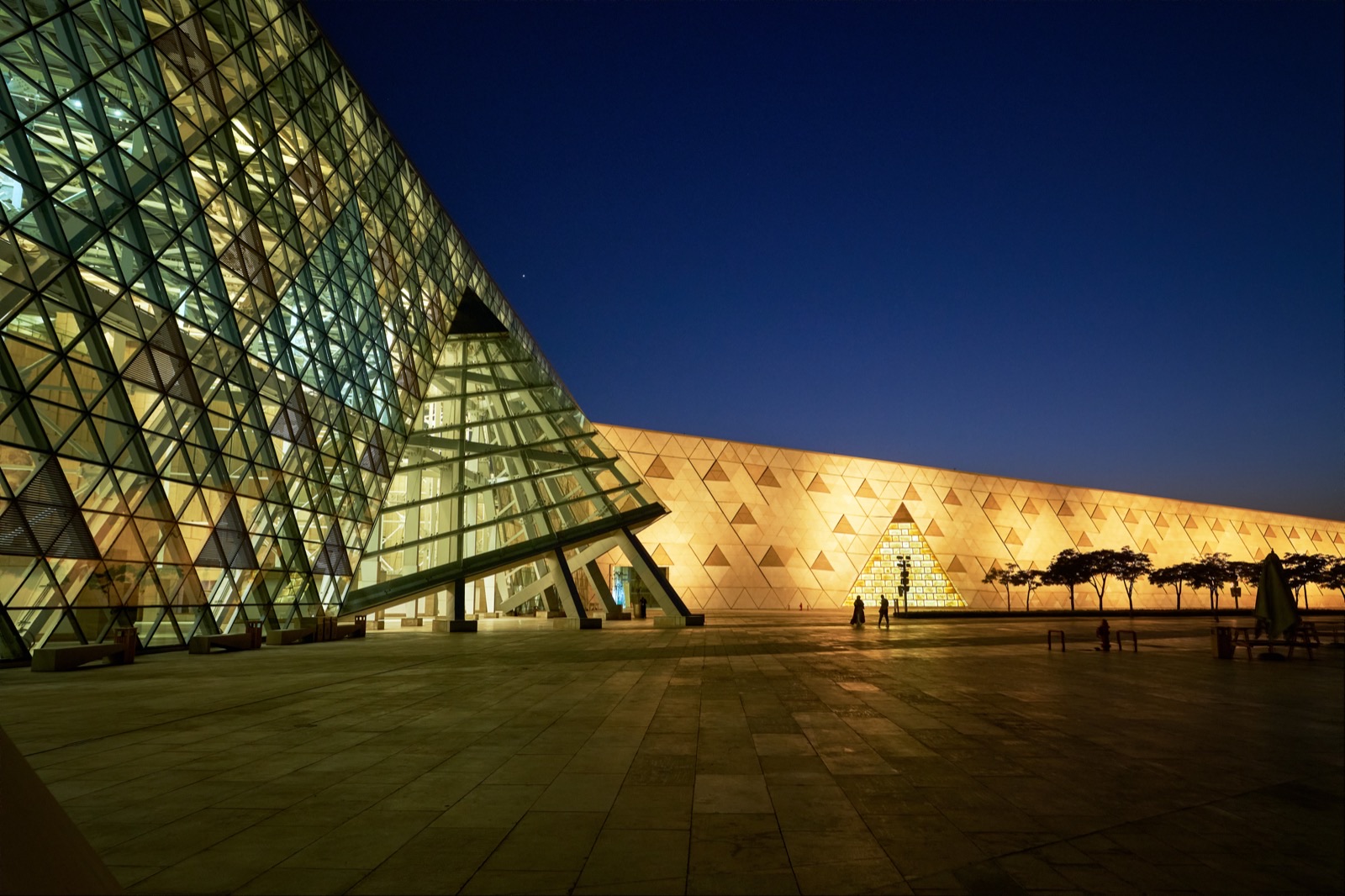 Night facade of the Grand Egyptian Museum beside the Giza Plateau