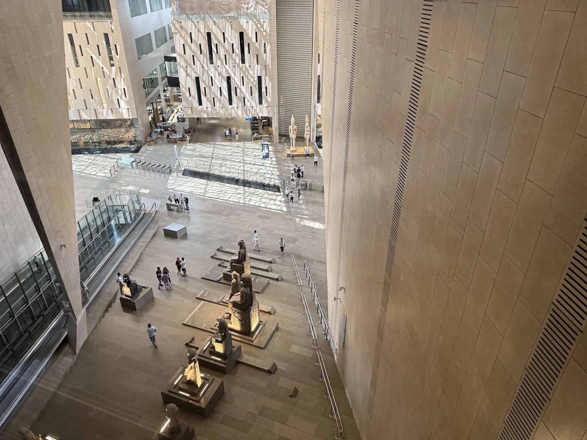 Interior of the Grand Egyptian Museum displaying ancient statues and artifacts