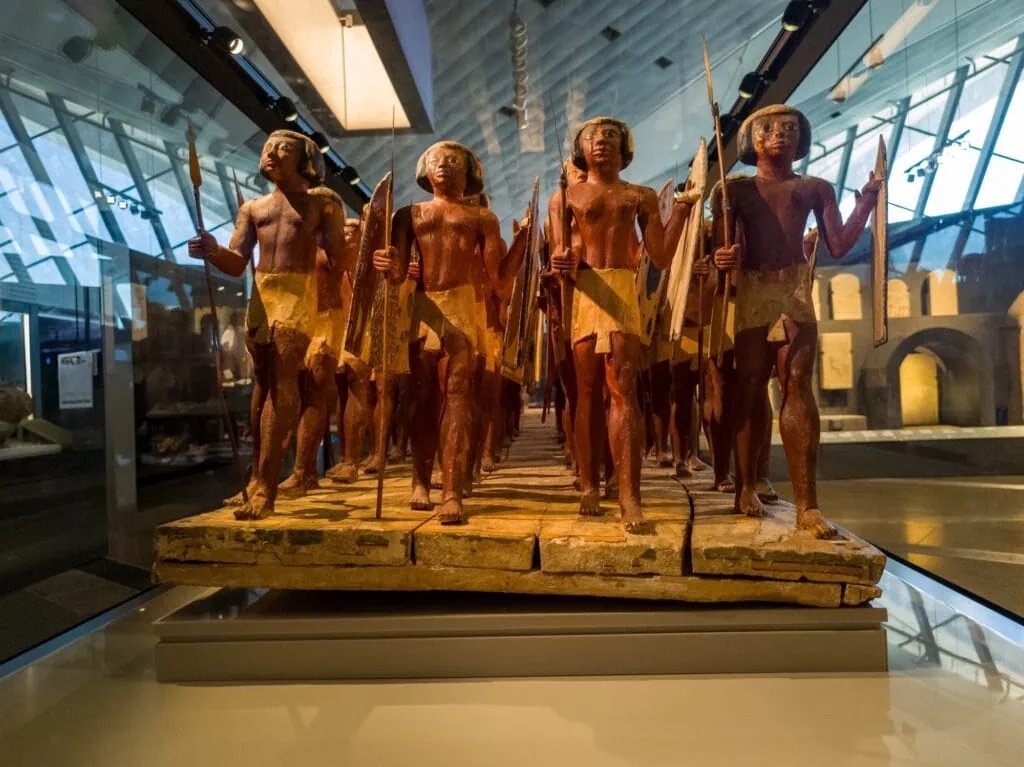 Wooden statues of ancient soldiers on display at the Grand Egyptian Museum