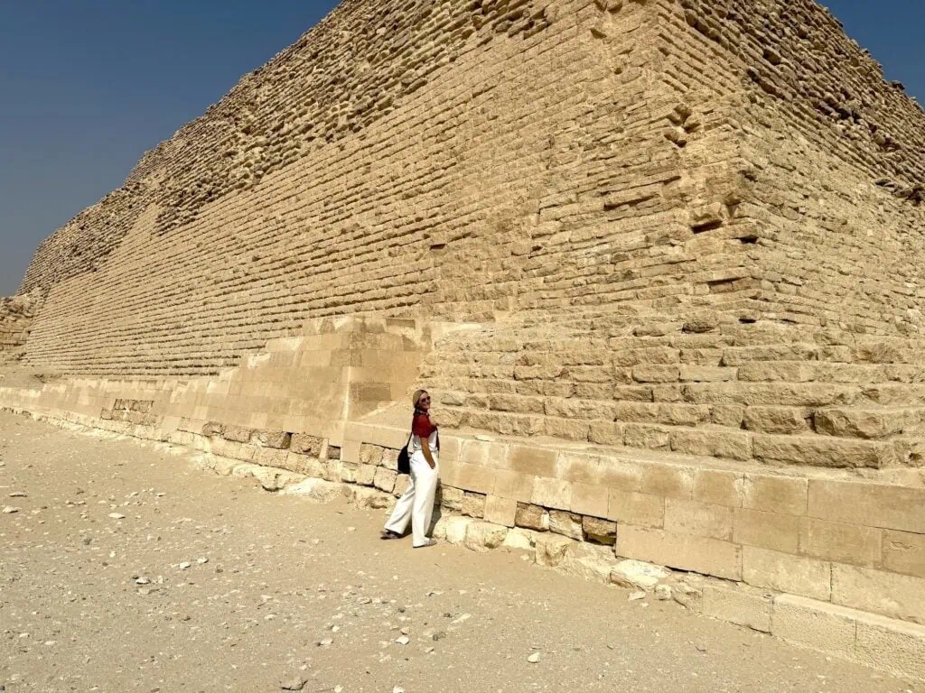 Tourist exploring the base of the Step Pyramid of Djoser